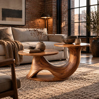 Coffee table with two disc tops at different heights on a swooping base in an industrial loft living room with exposed brick