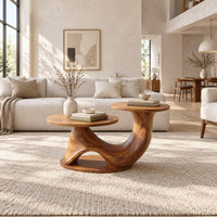 Coffee table with two disc tops at different heights on a swooping base in a bright open plan living room
