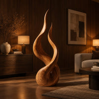 Twin flame wood sculpture with two tall tips and a smooth teardrop base in an evening living room with walnut wall paneling