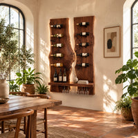 Twin live edge slab wine rack with angled pegs and a bottom shelf in a bright dining room with arched windows and plants