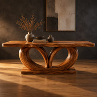 Rectangular dining table on a base of two large open loops in a dark studio against a charcoal plaster wall