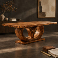 Corner detail of rectangular dining table on a base of two large open loops beside wood, brass and linen samples
