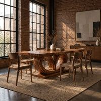 Rectangular dining table on a base of two large open loops in an industrial loft dining room with exposed brick