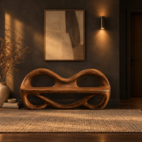 Wood bench with two looped openings above a flat plank seat in a dark entryway at golden hour