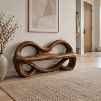 Wood bench with two looped openings above a flat plank seat in a Scandinavian entryway with white walls