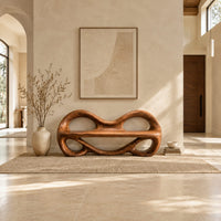 Wood bench with two looped openings above a flat plank seat in a bright open plan entryway