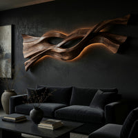 Twin strand wooden wall art with an eye shaped opening on a dark charcoal plaster wall
