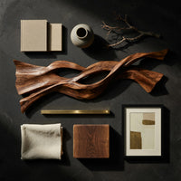 Detail of twin strand wooden wall art with an eye shaped opening beside wood, brass and linen samples