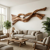 Twin strand wooden wall art with an eye shaped opening in a bright sunroom with green plants