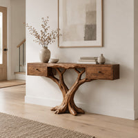 Console table with two small drawers on a twin trunk branching base in a Scandinavian entryway with white walls