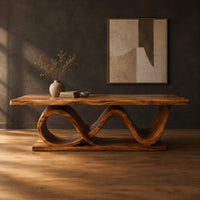 Dining table with a slab top on a twin wave ribbon base in a dark studio against a charcoal plaster wall