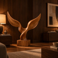 Twin wing sculpture with swept tips rising from a square wooden block in an evening living room with walnut wall paneling