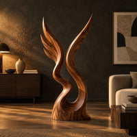 Twin wing sculpture rising from one swirled base to two sharp tips in a dark living room at golden hour