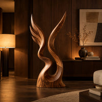 Twin wing sculpture rising from one swirled base to two sharp tips in an evening living room with walnut wall paneling