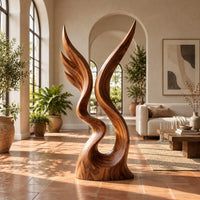 Twin wing sculpture rising from one swirled base to two sharp tips in a bright living room with arched windows and plants