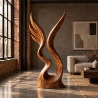 Twin wing sculpture rising from one swirled base to two sharp tips in an industrial loft living room with exposed brick