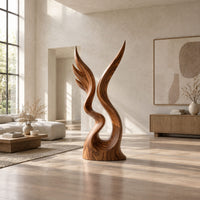 Twin wing sculpture rising from one swirled base to two sharp tips in a bright open plan living room