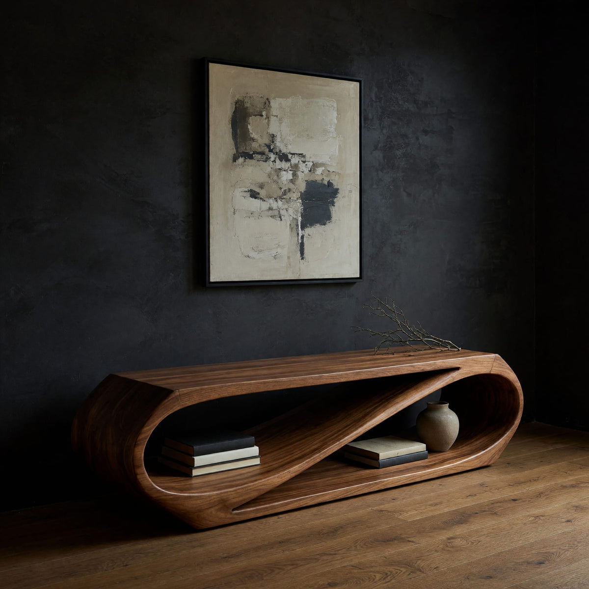 Twist loop TV console with a diagonal inner sweep in a dark studio against a charcoal wall