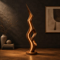 Tall floor lamp with a pointed tip, open twisting body and glowing edges in a dark studio against a charcoal plaster wall