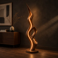 Tall floor lamp with a pointed tip, open twisting body and glowing edges, three-quarter view showing the grain