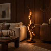 Tall floor lamp with a pointed tip, open twisting body and glowing edges in an evening living room with walnut wall paneling