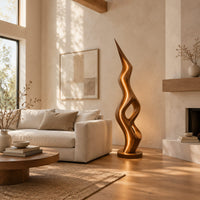 Tall floor lamp with a pointed tip, open twisting body and glowing edges in a bright open plan living room