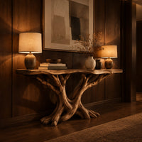 Console table with twisting branch legs, root like feet and a live edge top in an evening entryway with walnut wall paneling