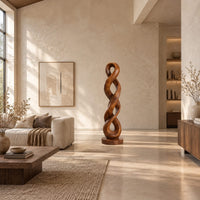 Twisted wood sculpture of two intertwined loops with a flat disc foot in a bright open plan living room