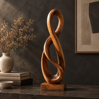Twisted figure eight wood sculpture with two open loops on a block base, three-quarter view showing the grain
