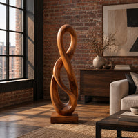 Twisted figure eight wood sculpture with two open loops on a block base in an industrial loft living room with exposed brick