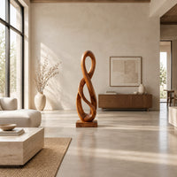 Twisted figure eight wood sculpture with two open loops on a block base in a bright open plan living room