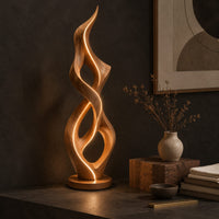 Corner detail of tall twisted flame floor lamp on a low disc base beside wood, brass and linen samples