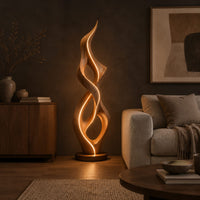 Tall twisted flame floor lamp on a low disc base in a dark living room at golden hour