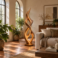 Tall twisted flame floor lamp on a low disc base in a bright living room with arched windows and plants
