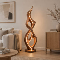 Tall twisted flame floor lamp on a low disc base in a Scandinavian living room with white walls