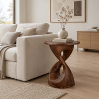 Twisted hourglass side table with a thin flat top and open waist in a Scandinavian living room with white walls