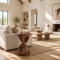 Twisted hourglass side table with a thin flat top and open waist in a bright open plan living room