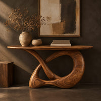 Corner detail of console table with a twisted knot loop base and an oval top beside wood, brass and linen samples