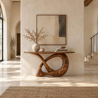 Console table with a twisted knot loop base and an oval top in a bright open plan entryway