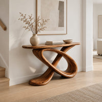 Console table with a twisted loop base and a slim oval top in a Scandinavian entryway with white walls