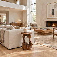 Side table with a circular top on a twisted open loop base in a bright open plan living room
