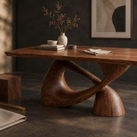 Corner detail of dining table with a rectangular top on a twisted loop pedestal beside wood, brass and linen samples