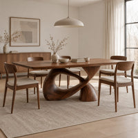 Dining table with a rectangular top on a twisted loop pedestal in a Scandinavian dining room with white walls