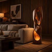 Twisted floor lamp with open loops and a glowing hollow base in an evening living room with walnut wall paneling
