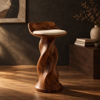 Bar stool with a twisted pedestal, a flared foot and a scooped wood seat, three-quarter view showing the grain