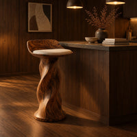 Bar stool with a twisted pedestal, a flared foot and a scooped wood seat in an evening kitchen with walnut wall paneling