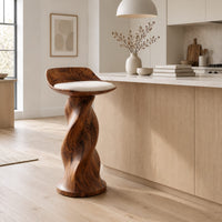 Bar stool with a twisted pedestal, a flared foot and a scooped wood seat in a Scandinavian kitchen with white walls