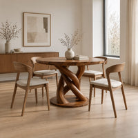 Circular wooden dining table with a twisting braided pedestal on a disc base in a Scandinavian dining room with white walls