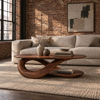 Oval coffee table on a twisted ribbon base with a flat oval shelf below in an industrial loft living room with exposed brick