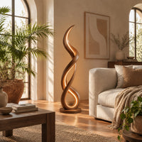 Floor lamp of twisting wooden ribbon with a glowing loop at the base in a bright living room with arched windows and plants
